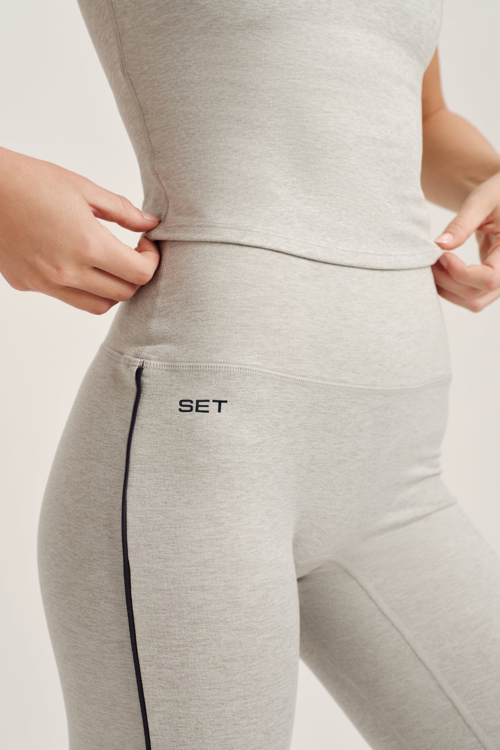 Gray leggings with 'SET' logo on a light background