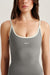 Gray tank top with white trim worn by a person on a plain background