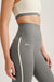 Gray leggings with a white stripe and 'SET' branding on a neutral background