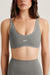 Woman wearing a gray sports bra and leggings with 'SET' branding.