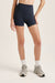 Person wearing navy blue athletic shorts on a plain background <model-info>Kalia wears a size XS and is 5’9 , 23” waist, 32B bust.</model-info>