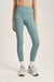 Person wearing light blue leggings with a visible brand logo on a plain background <model-info>Kalia wears a size XS and is 5’9 , 23” waist, 32B bust.</model-info>