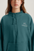 Teal hoodie with a brand logo on a plain background