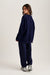 Person wearing a navy blue tracksuit on a white background