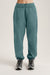 Teal sweatpants worn by a person on a plain background <model-info>Bella wears a size S and is 5’7, 23” waist, 32AB bust.</model-info> 