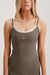 Woman wearing a gray tank top with 'SET' branding on a light background
