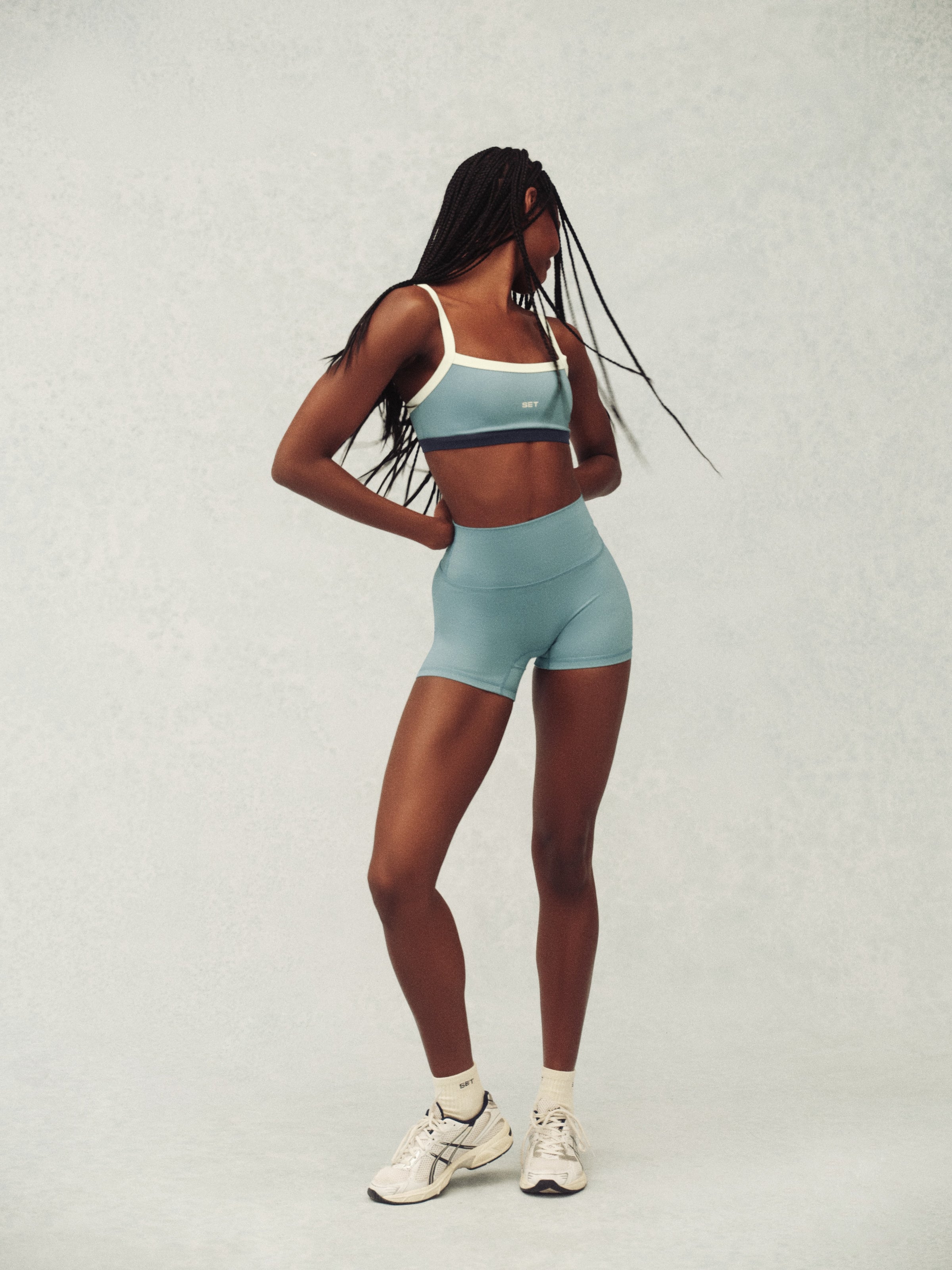 Person wearing a light blue athletic outfit on a plain background