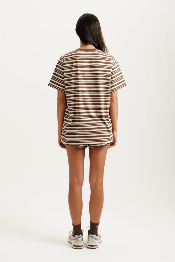 Person wearing a striped t-shirt and shorts on a white background