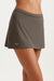 Brown skirt worn by a person on a white background