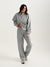 Woman wearing a gray tracksuit on a white background