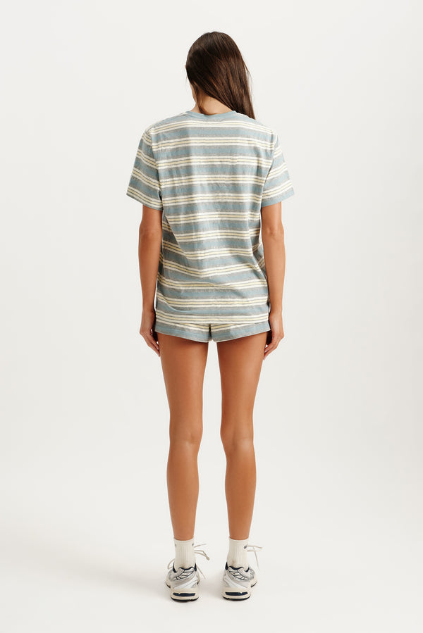 Person wearing a striped shirt and shorts on a white background