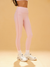 Person wearing pink leggings and white sneakers on a beige background