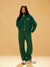 Person wearing a green tracksuit on a beige background