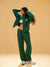 Woman wearing a green tracksuit against a beige background <model-info>Meeya wears a size S and is 5’7, 23” waist, 32B bust.</model-info> 