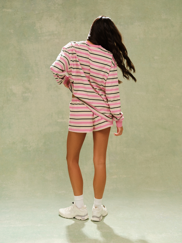 Person wearing a pink and white striped outfit on a plain background