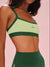 Green sports bra with 'SET' branding on a pink background