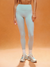 Person wearing light blue leggings on an orange background