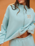 Light blue tracksuit with 'SET' branding on an orange background