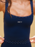 Navy blue sports bra with 'SET' logo on a beige background