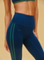 Blue leggings with green stripes and 'SET' branding on a beige background
