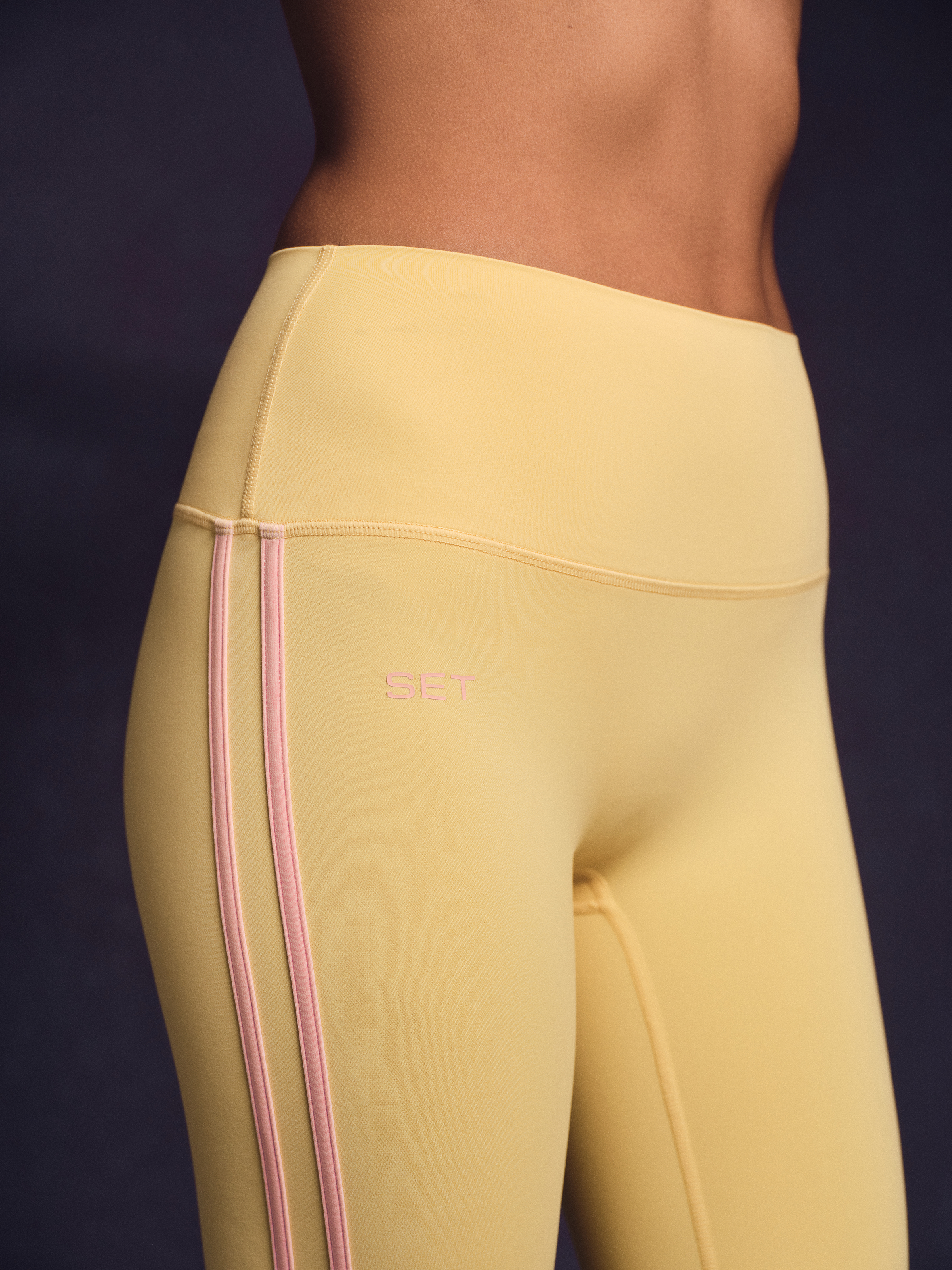 Yellow leggings with pink stripes on a dark background