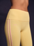 Yellow leggings with pink stripes on a dark background