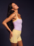 Woman wearing a purple and yellow athletic outfit against a dark background