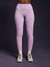 Person wearing light purple leggings on a dark background