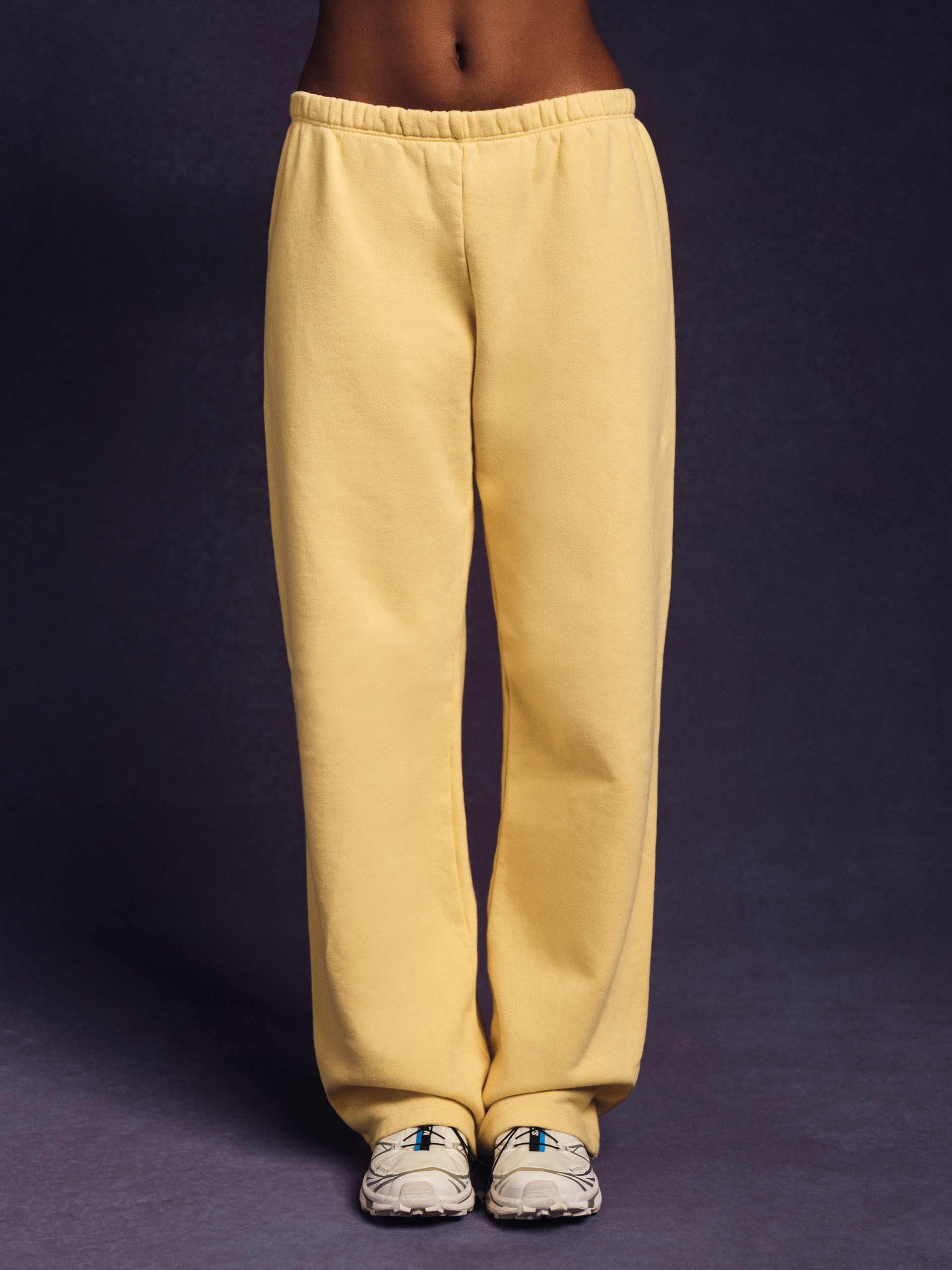 Front view of yellow sweatpants with relaxed straight leg fit