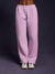 Person wearing light purple sweatpants on a dark background