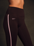 Black leggings with a pink stripe and 'SET' logo on a dark background