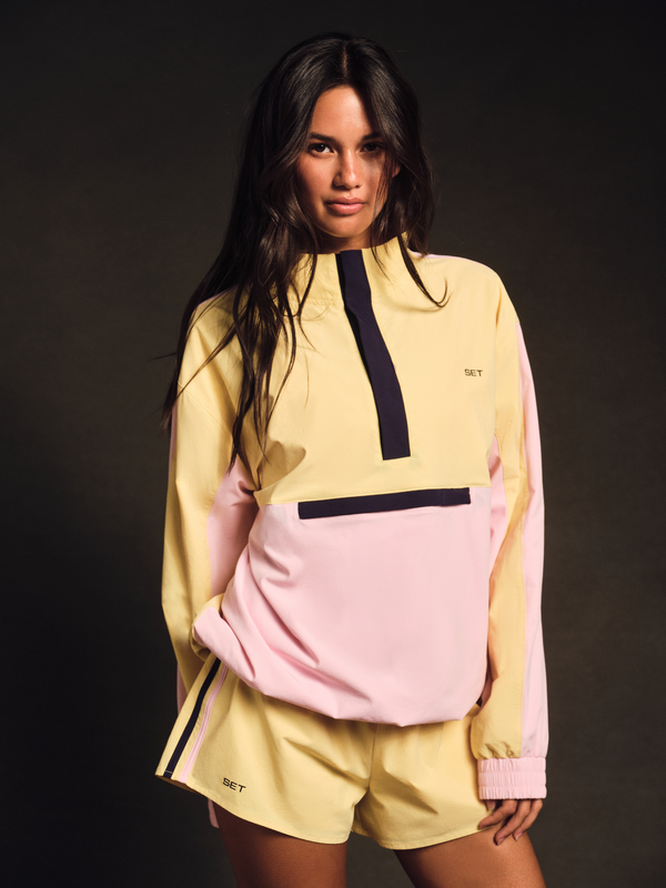 Person wearing a colorful outfit with a dark background  