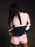 Person wearing a pink and navy tracksuit against a dark background <model-info>Umi wears a size S and is 5’8½”, 23½” waist, 32B bust.</model-info>