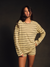 Person wearing a yellow and black striped shirt against a dark background <model-info>Jelene wears a size S and is 5’7”, 23” waist, 32AB bust.</model-info>