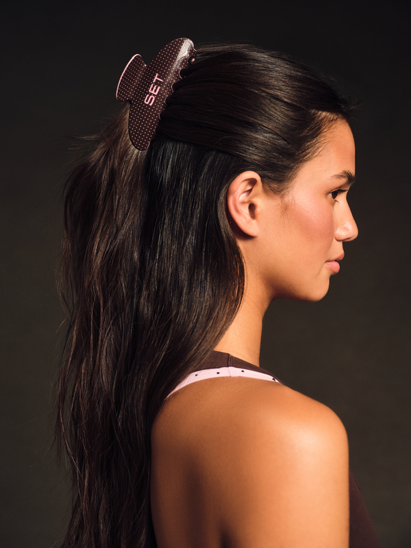 Woman with a hair clip on a dark background