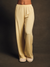 Yellow pajama pants worn by a person on a dark background