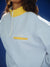 Light blue jacket with yellow collar and logo against a blue background