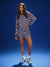 Woman wearing a red and white striped outfit on a blue background