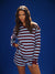 Woman wearing a striped dress against a blue background <model-info>Kushi wears a size XS and is 5'8, 24” waist, 32C bust.</model-info>