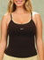 A woman wearing a black ribbed camisole tank top with beige trim and dotted straps, featuring the word 'SET' printed in beige on the chest. <model-info>Raine wears a size L and is 5’8”, 29½” waist, 34” bust.</model-info>