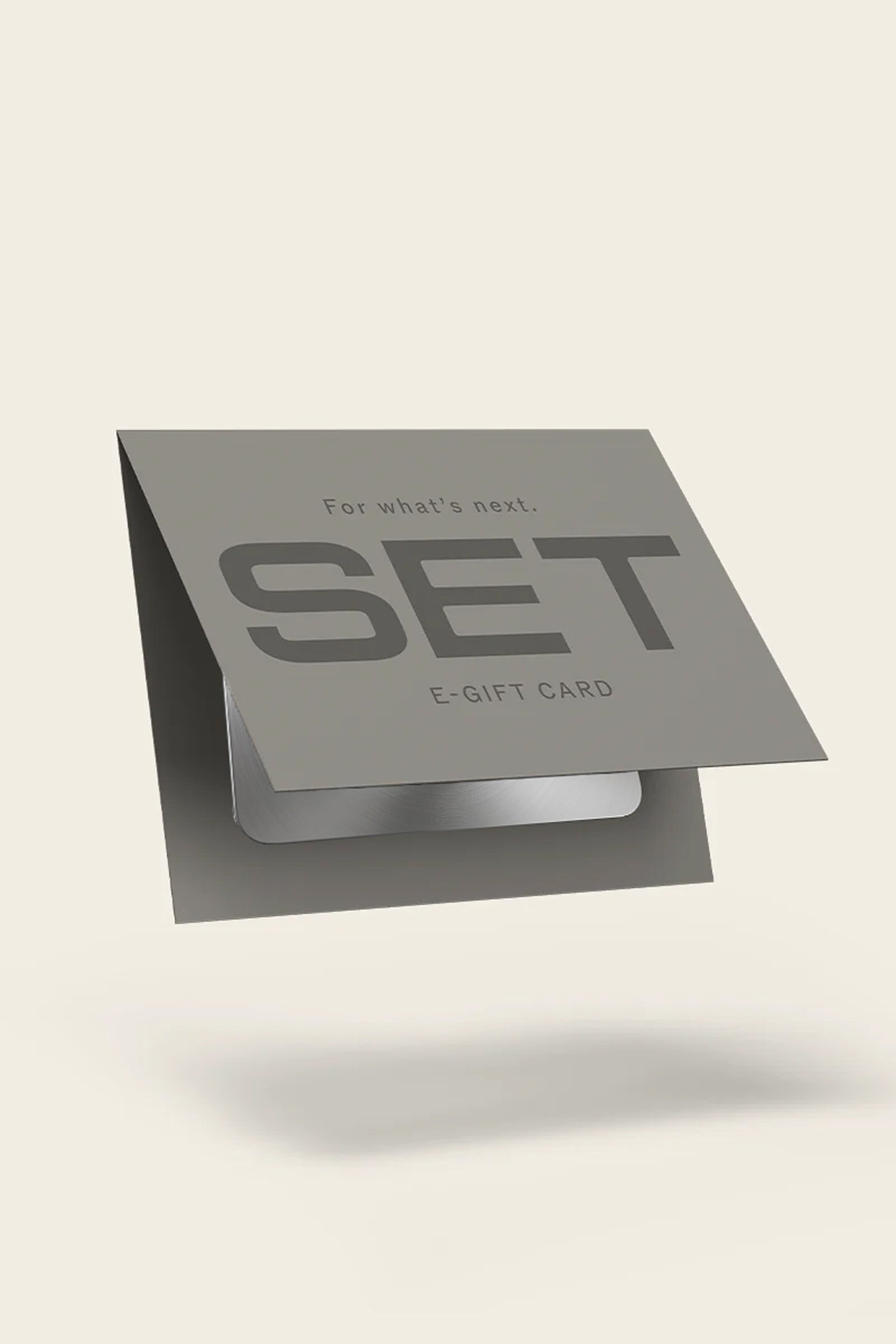 A gray promotional e-gift card labeled 'SET' and 'E-GIFT CARD' floating on a light beige background with a soft shadow underneath.