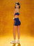 Woman wearing a sports bra and shorts on an orange background