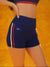 Navy blue athletic shorts with red and white accents on a bright orange background <model-info>Jasmine wears a size S and is 5'8, 25” waist, 32C bust.</model-info>