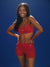 Woman wearing a red sports bra and shorts on a blue background