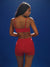 Person wearing a red sports bra and shorts set against a blue background
