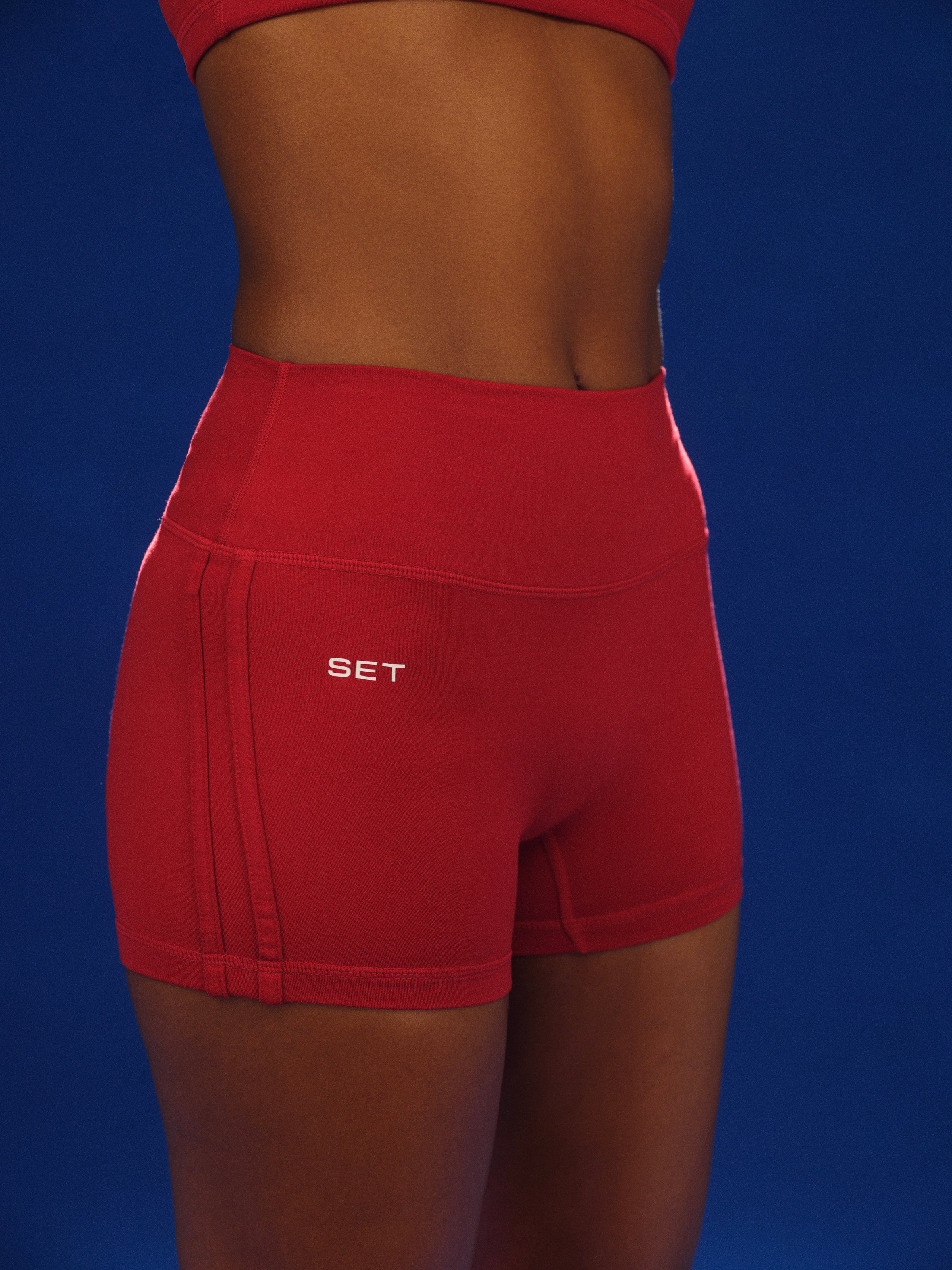 Red shorts with 'SET' logo on a blue background 