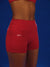 Red shorts with 'SET' logo on a blue background <model-info>Umi wears a size XS and is 5’8½”, 23½” waist, 32B bust.</model-info>