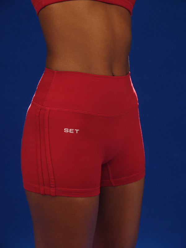 Red shorts with 'SET' logo on a blue background 