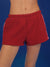 Red shorts worn by a person on a blue background <model-info>Amanda wears a size S and is 5'9, 24” waist, 32B bust.</model-info>