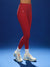 Red leggings worn by a person on a blue background